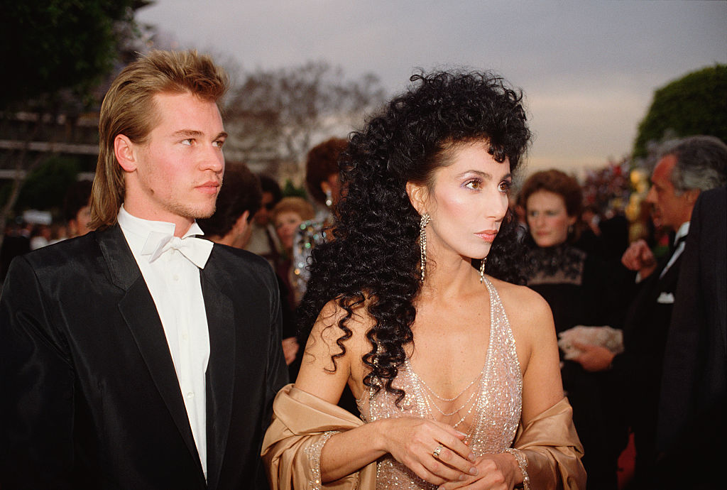 American actors Cher and Val Kilmer arrive at the 56th Academy Awards, where Cher is nominated for Best Supporting Actress in Silkwood.