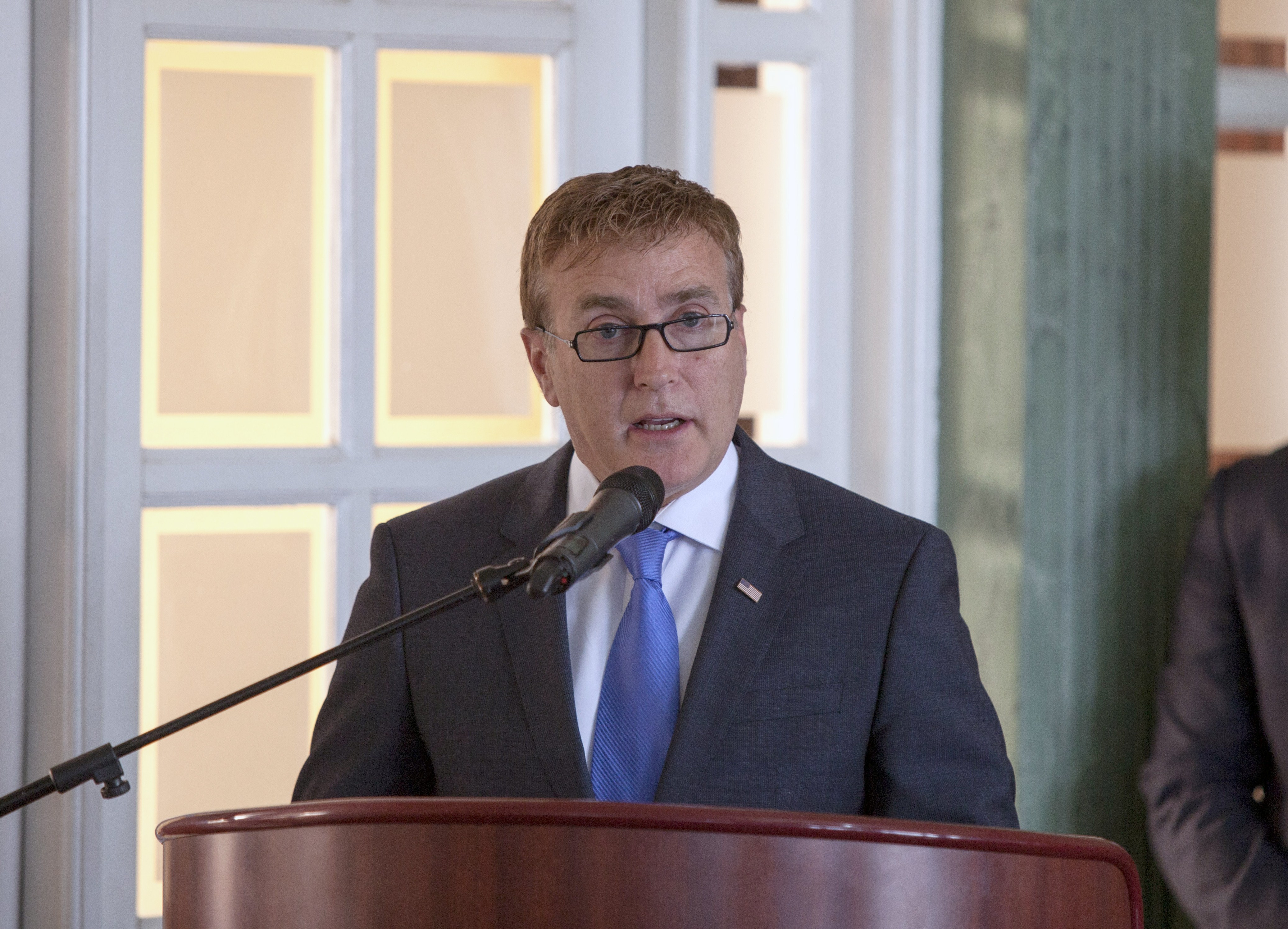 Groups attack US ambassador for taking husband to school