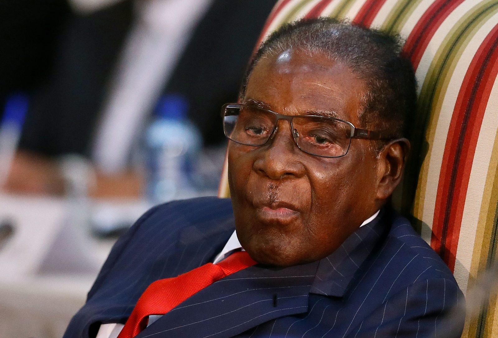 Robert Mugabe clings to power after being ousted as party leader