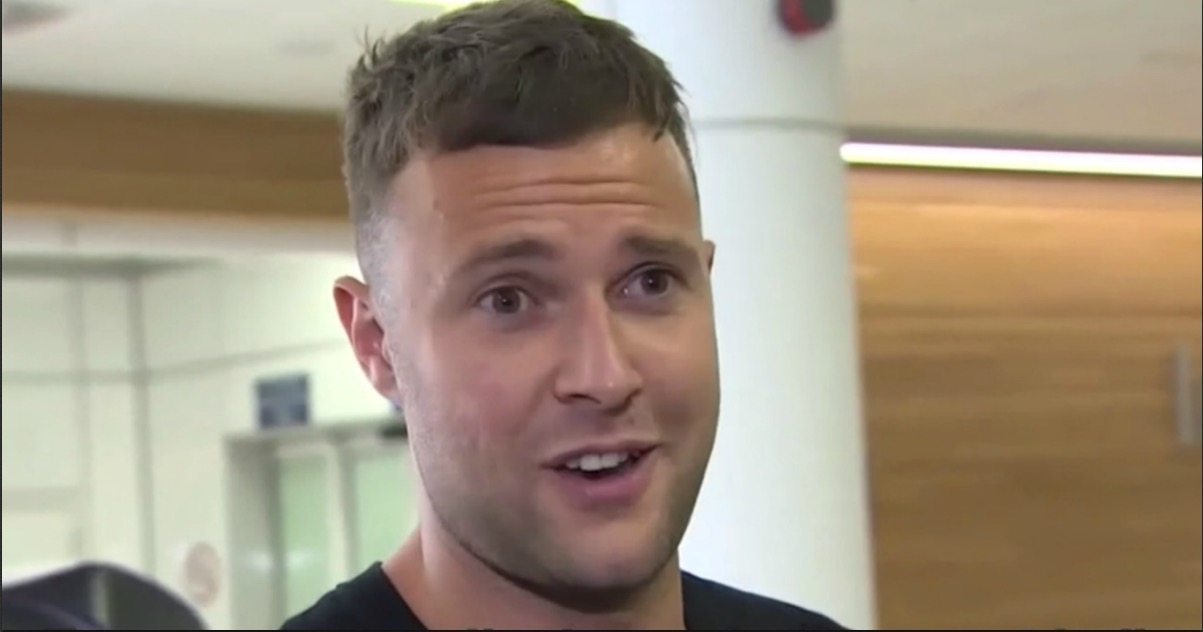 British man sentenced for ‘touching man’s hip’ finally back home