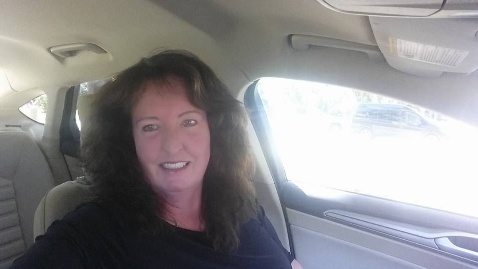 Elizabeth McCarthy smiling in the back of a car