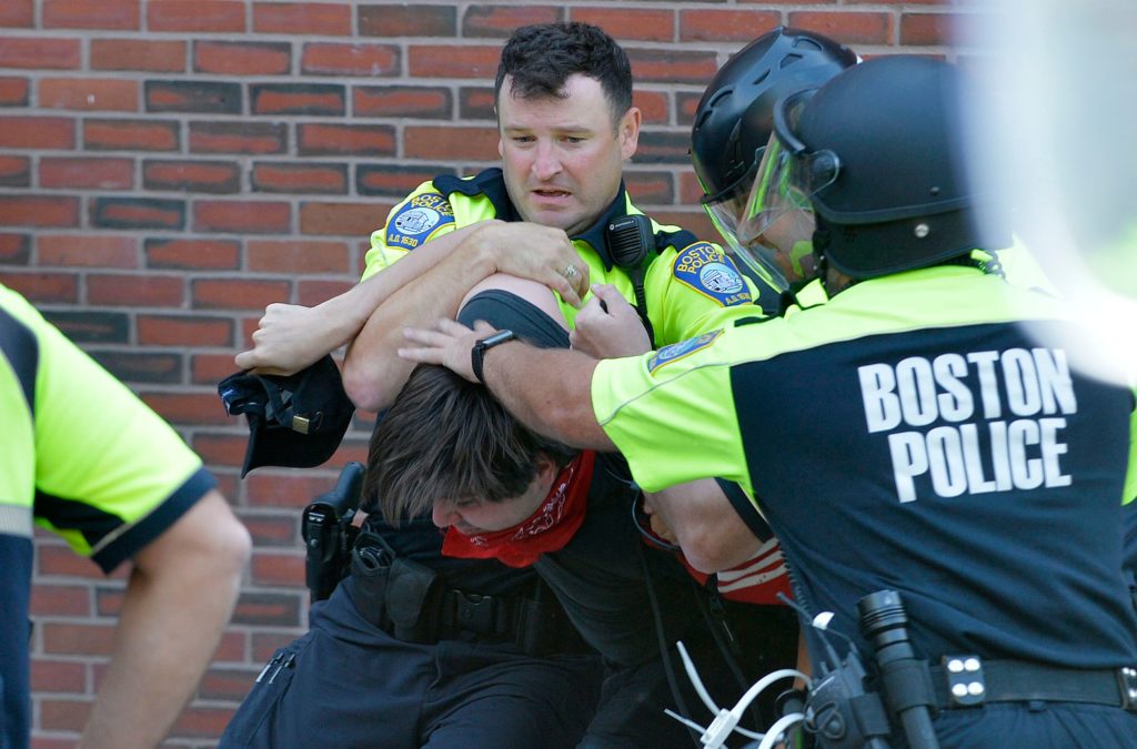 Boston Police officers arrest an anti-parade demonstrator during the &quot;Straight Pride&quot; parade in Boston, on August 31, 2019. 