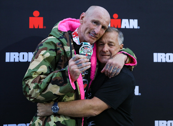 Gareth Thomas shows his finishers medal as he celebrates with his partner on completing his first Ironman triathlon. (Huw Fairclough/Getty Images)
