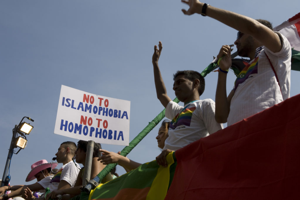Members of Imaan wave from atop a float during the EuroPride parade.