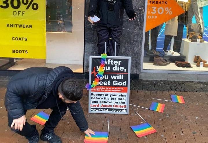 Street preacher who thinks homosexuality is an 'abomination' surrounded by rainbow flags in 'big circle of gay love'