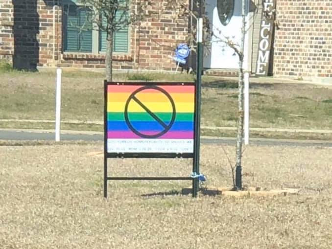 Pastor displays homophobic sign after realising lesbian neighbours weren't roommates after all