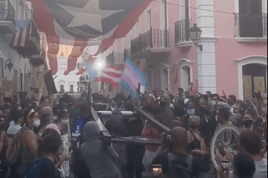 Puerto Ricans bring out a guillotine and trans Pride flags as hundreds join Black Lives Matter protest