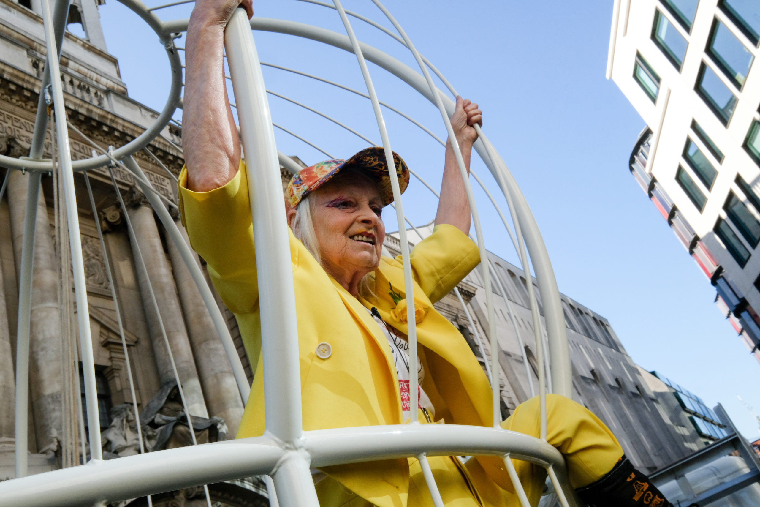 Vivienne Westwood casually swings inside a giant birdcage outside the Old Bailey to support Julian Assange
