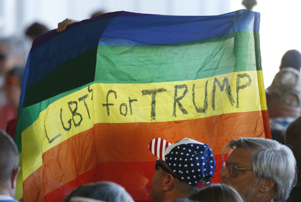 Supporters hold up an LGBT+ Pride flag for Republican presidential candidate Donald Trump. (George Frey/Getty Images