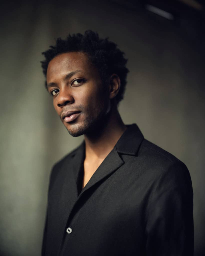 Omari in a black suit jacket 