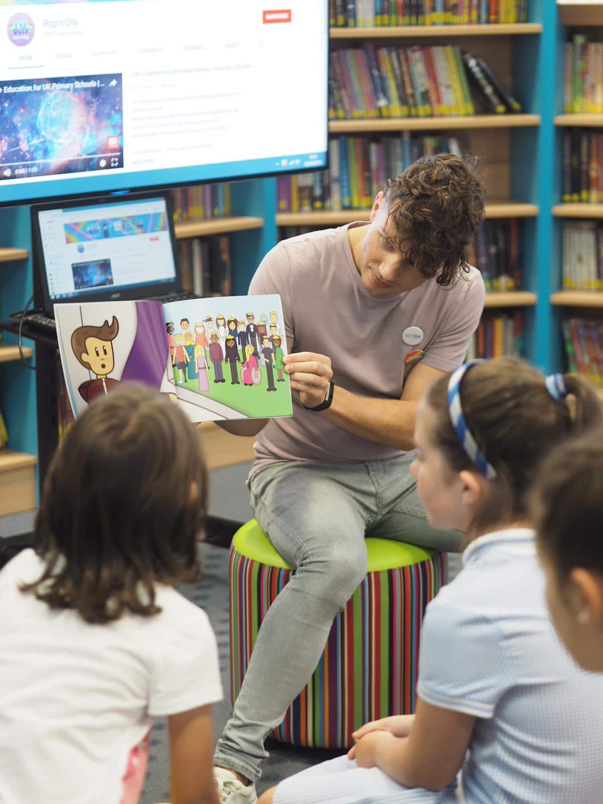 Olly Pike reading a picture book to children