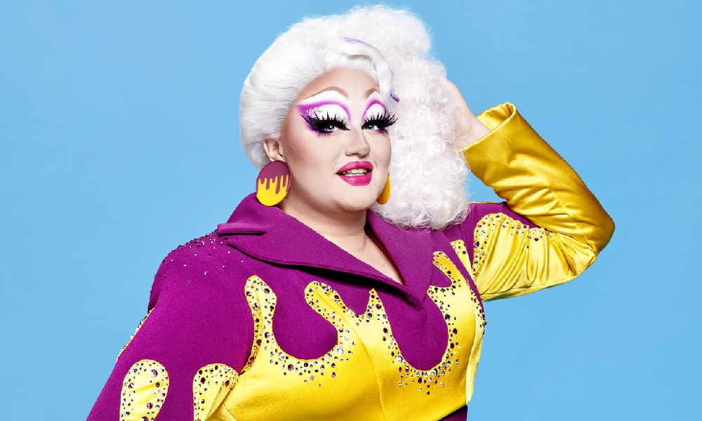 Victoria Scone wearing a purple jumpsuit with yellow, gem-encrusted flames