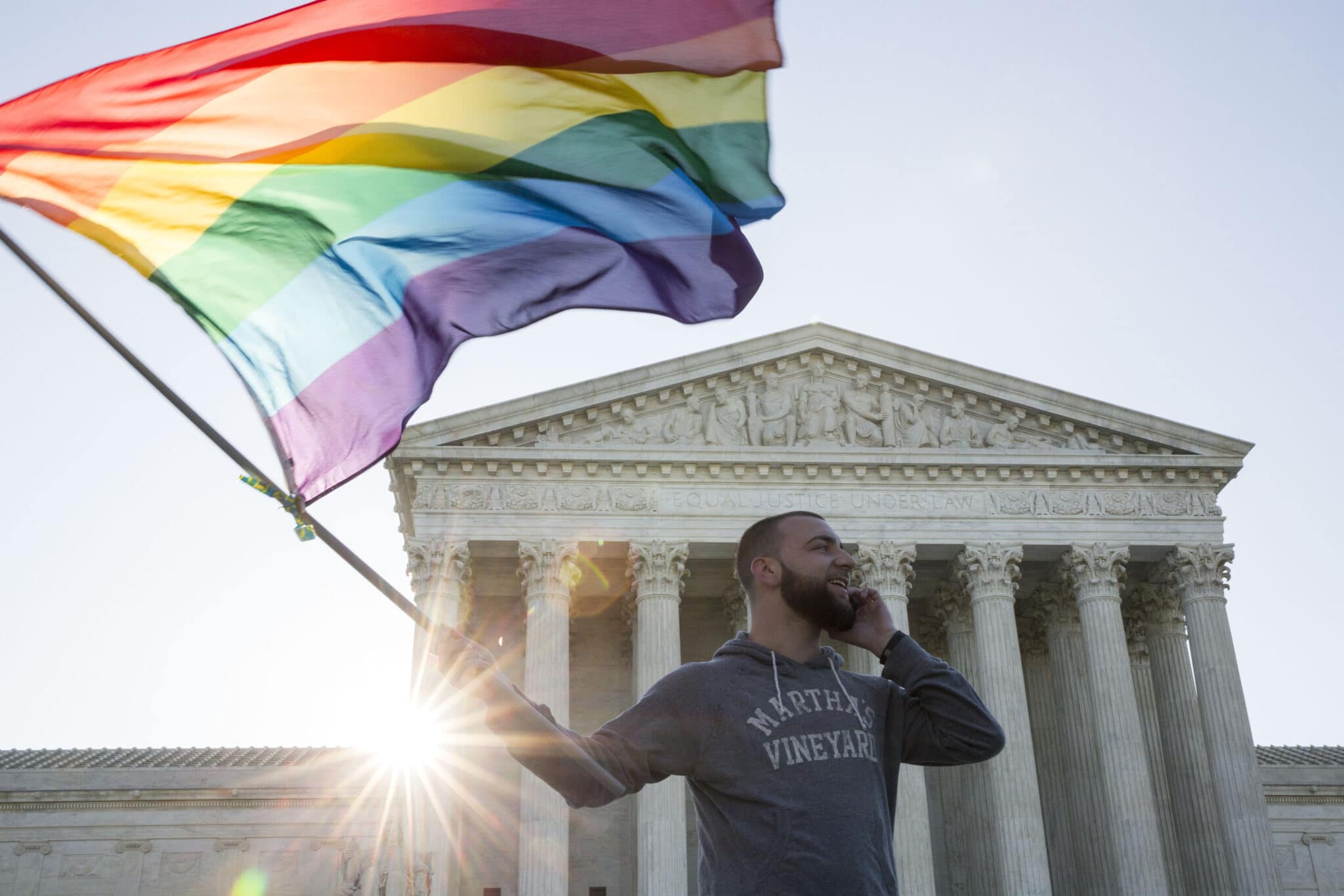 Same-sex marriage supporter Vin Testa, of Washington DC, waves a rainbow pride flag near the Supreme Court