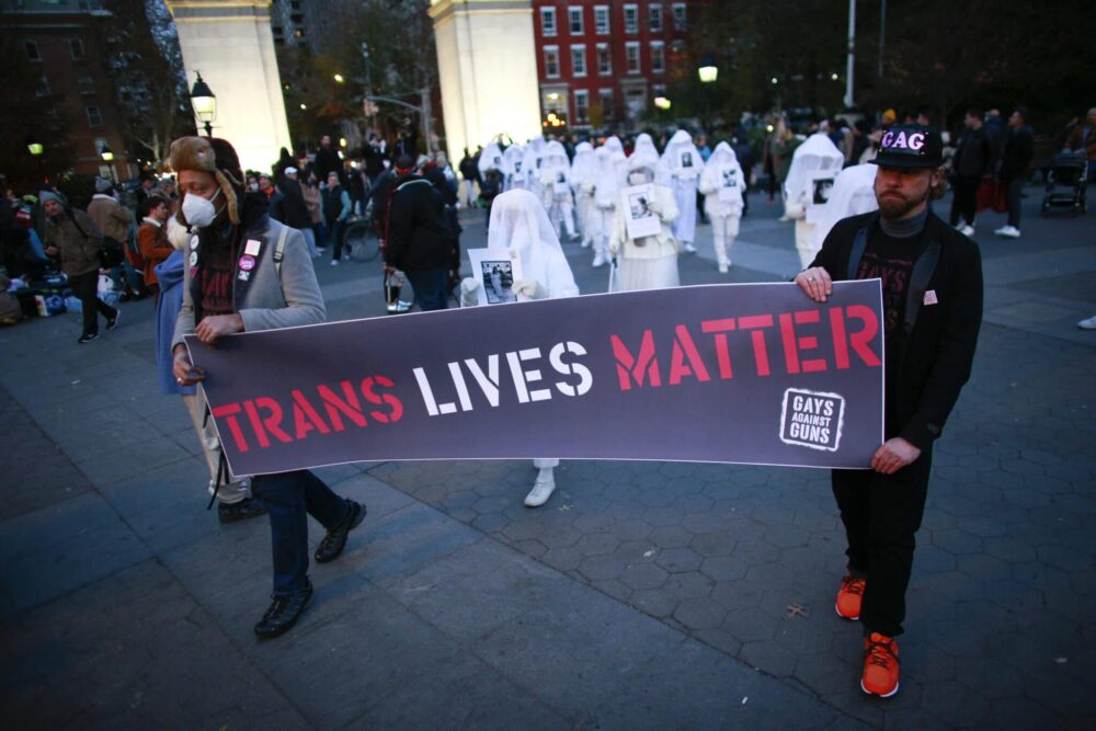 People hold a &quot;Trans Life Matter&quot; banner at the Transgender Day of Remembrance in Washington square park, New York