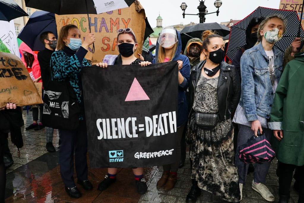 A protester holds a placard with the symbol of a pink triangle, historically used by nazis to mark homosexual people. 