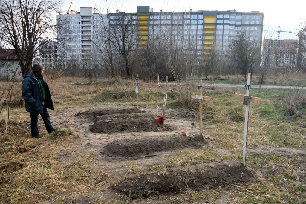 Graves with bodies of civilians next to apartments blocks in the recaptured by the Ukrainian army Bucha city near Kyiv, Ukraine, 04 April 2022.