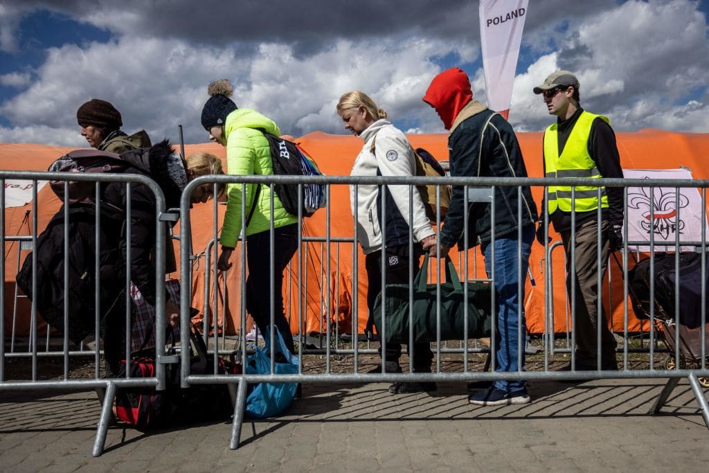 Refugees from Ukraine wait for the bus after they crossed the Ukrainian-Polish border at the border crossing in Medyka, southeastern Poland on April 8, 2022.