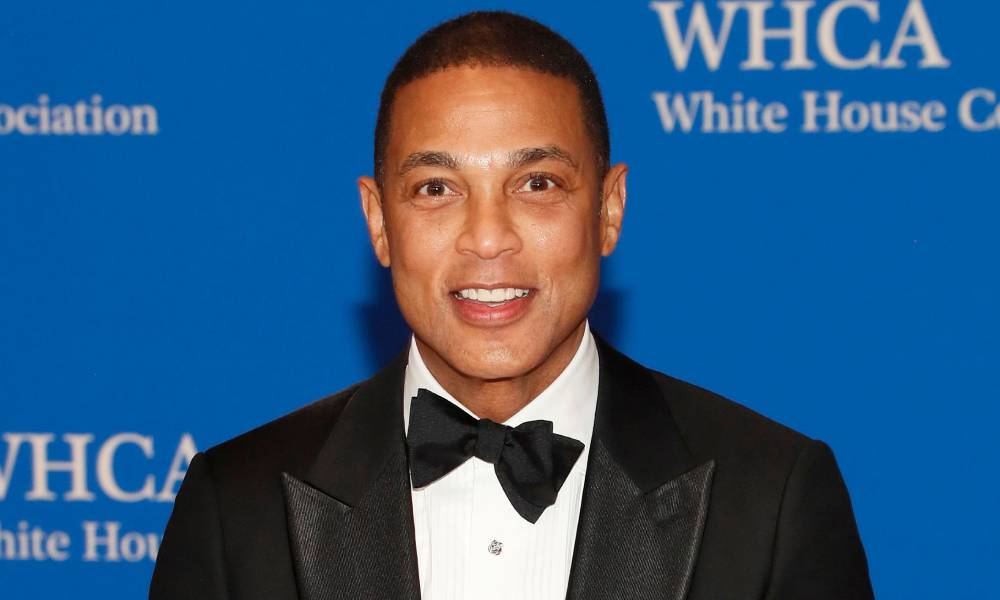 Journalist Don Lemon smiles at the camera while wearing a white shirt black bow tie and black suit jacket