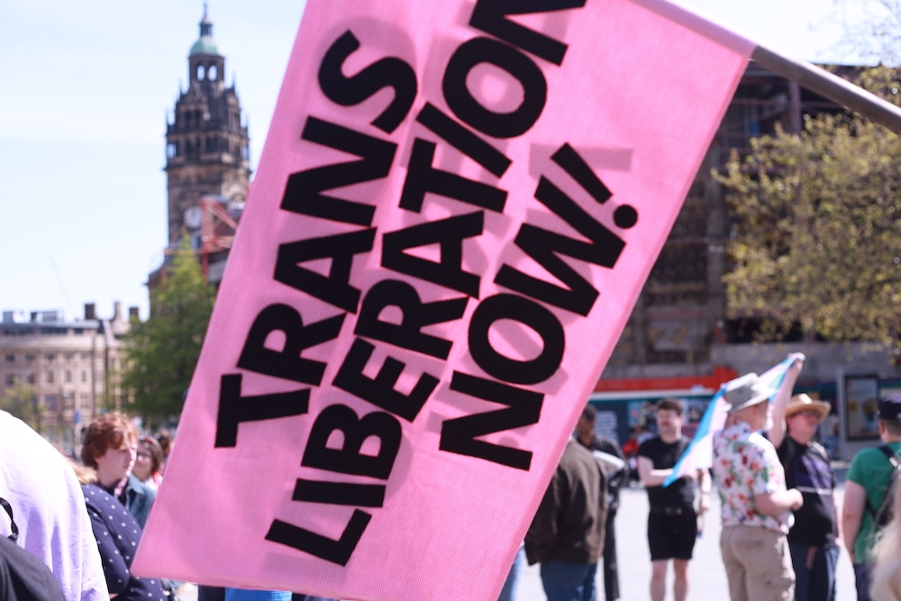 A flag reads &quot;trans liberation now&quot;