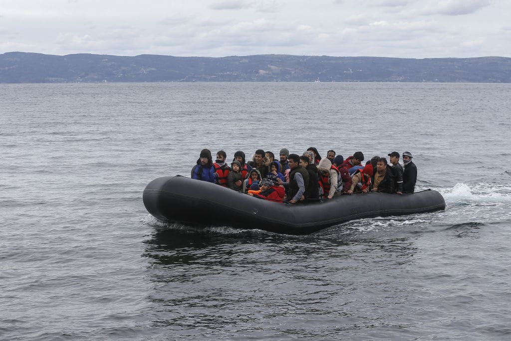 Migrants escaped from civil war in Syria, who want to proceed to Europe, arrive with a boat at a shore in Lesbos Island on Greece on February 28, 2020. 