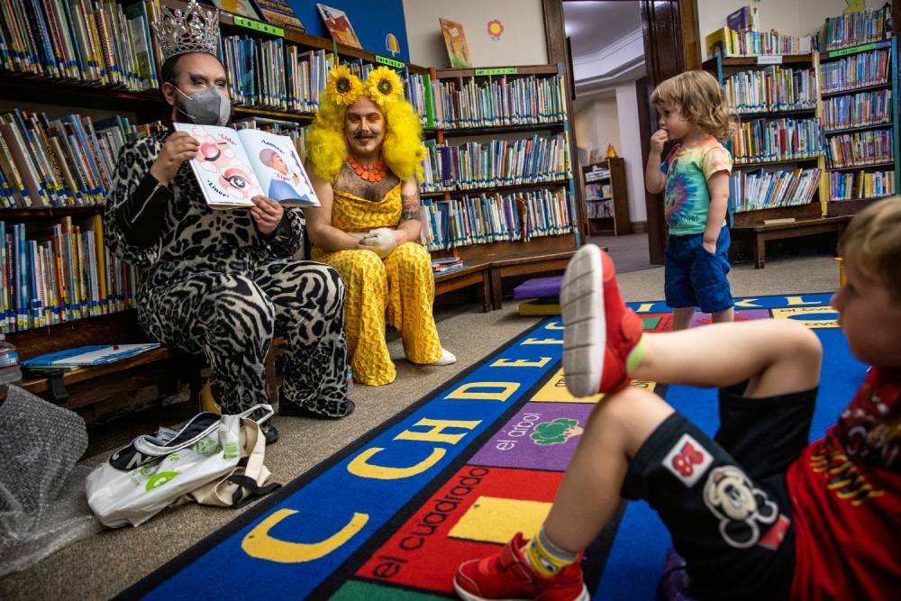 Two drag performers read from a children