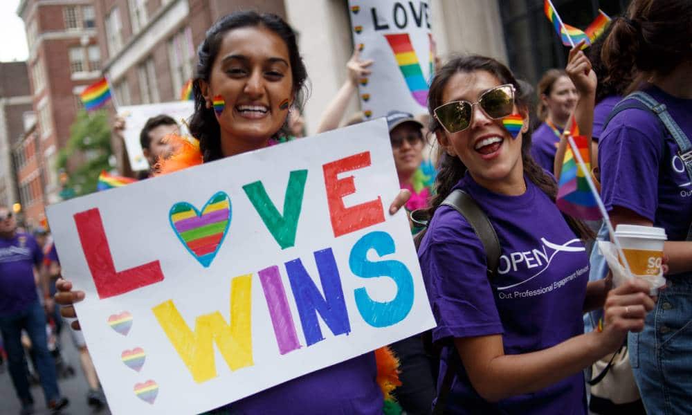 Revelers hold up a sign reading &quot;Love wins&quot; in rainbow coloured letters as they participate in the Philadelphia LGBT Pride Parade through the city