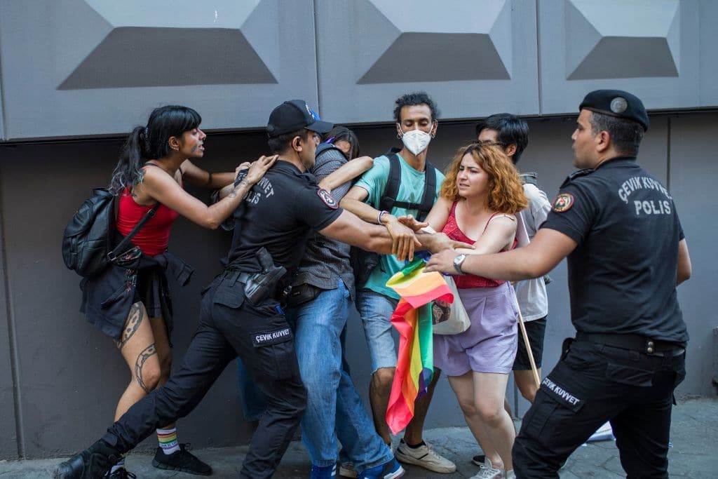 A Turkish policeman detains a demonstrator during a Pride march in Istanbul