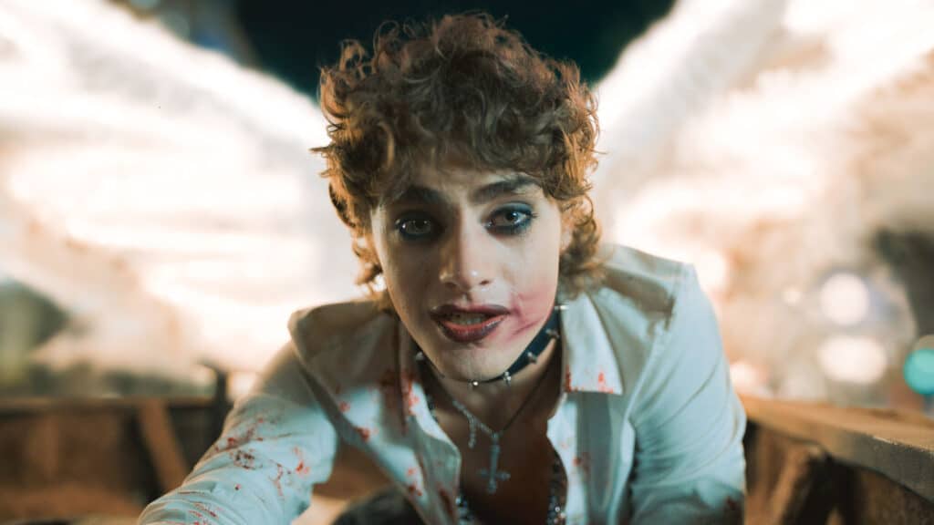 Mingus leaning over the camera with white angel wings