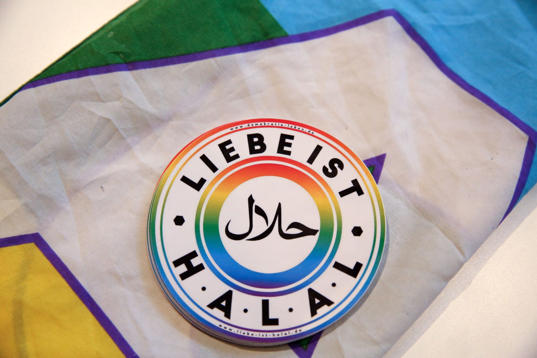 A sticker reading &quot;Love is Halal&quot; lies atop a rainbow flag inside the Ibn Rushd-Goethe mosque in Berlin after a larger rainbow flag was hung on the building
