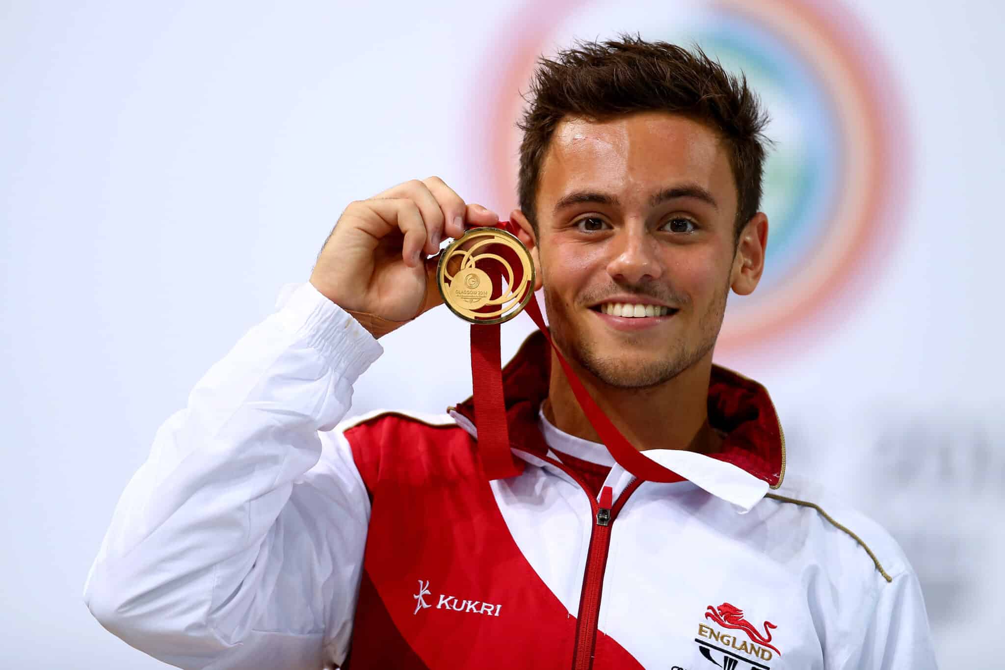 Tom Daley of England celebrates on the podium after winning the Gold medal in the Men