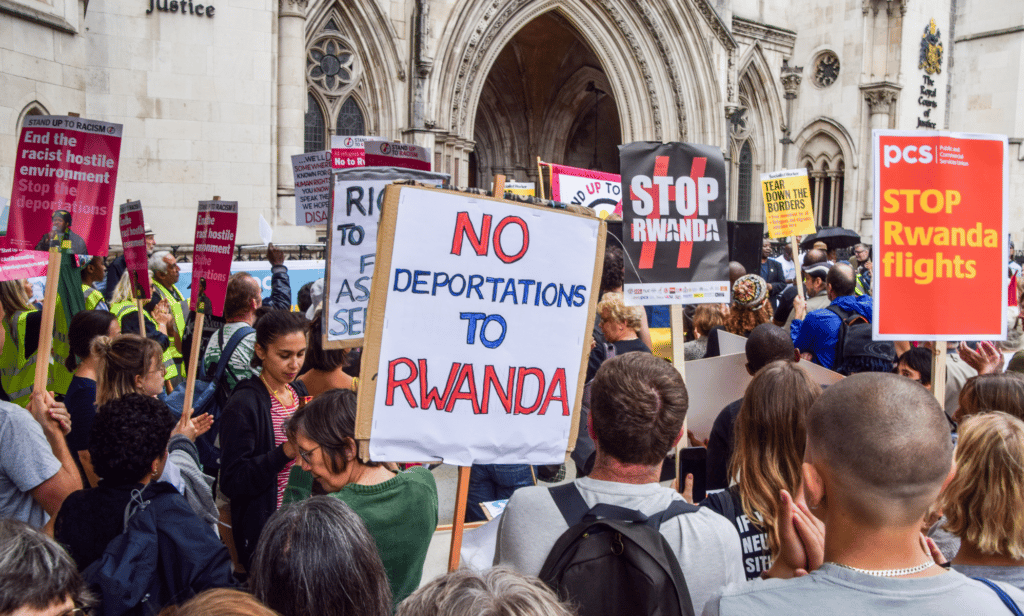 People gather outside the High Court to protest against Priti Patel
