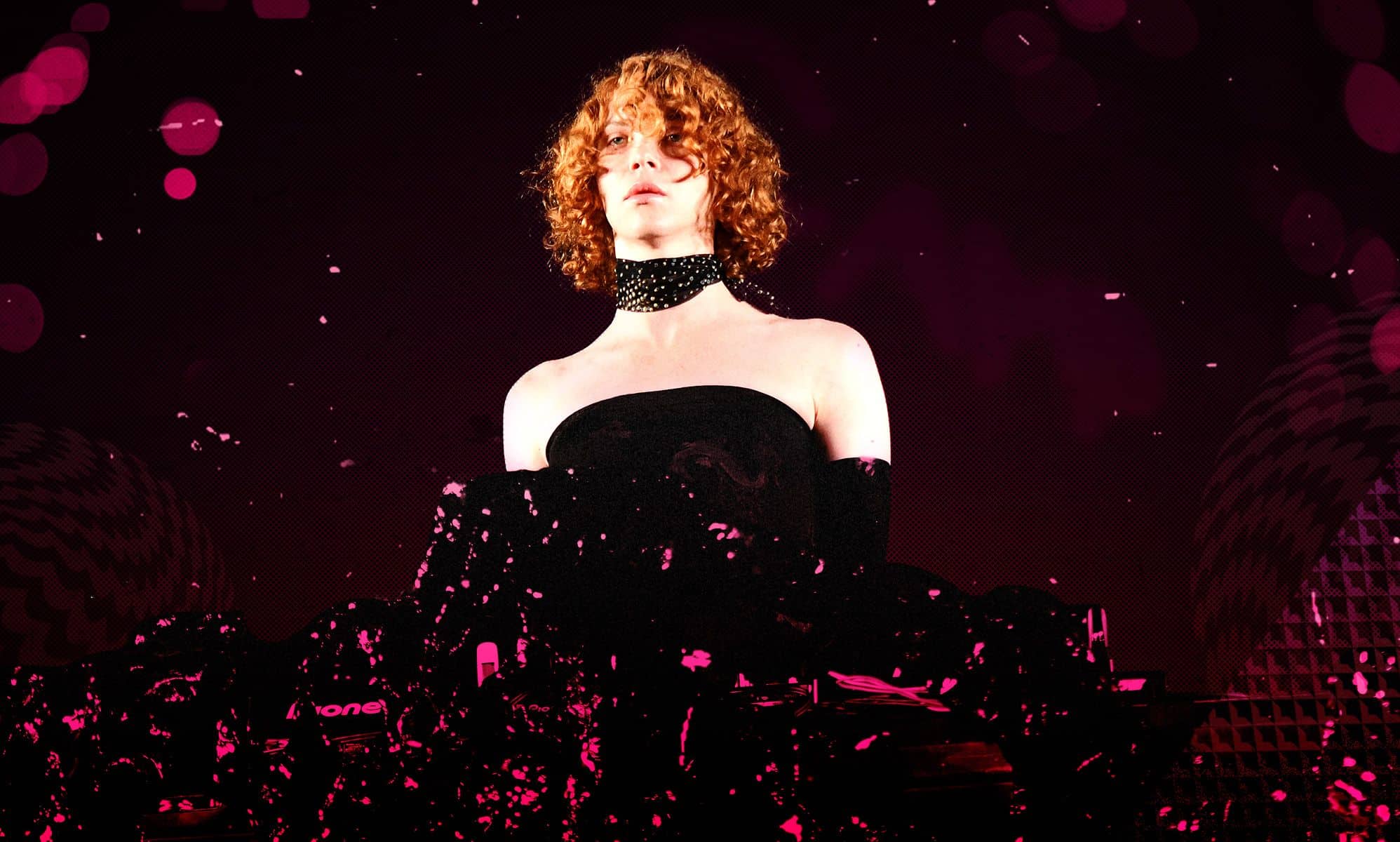 SOPHIE in a black and pink dress.