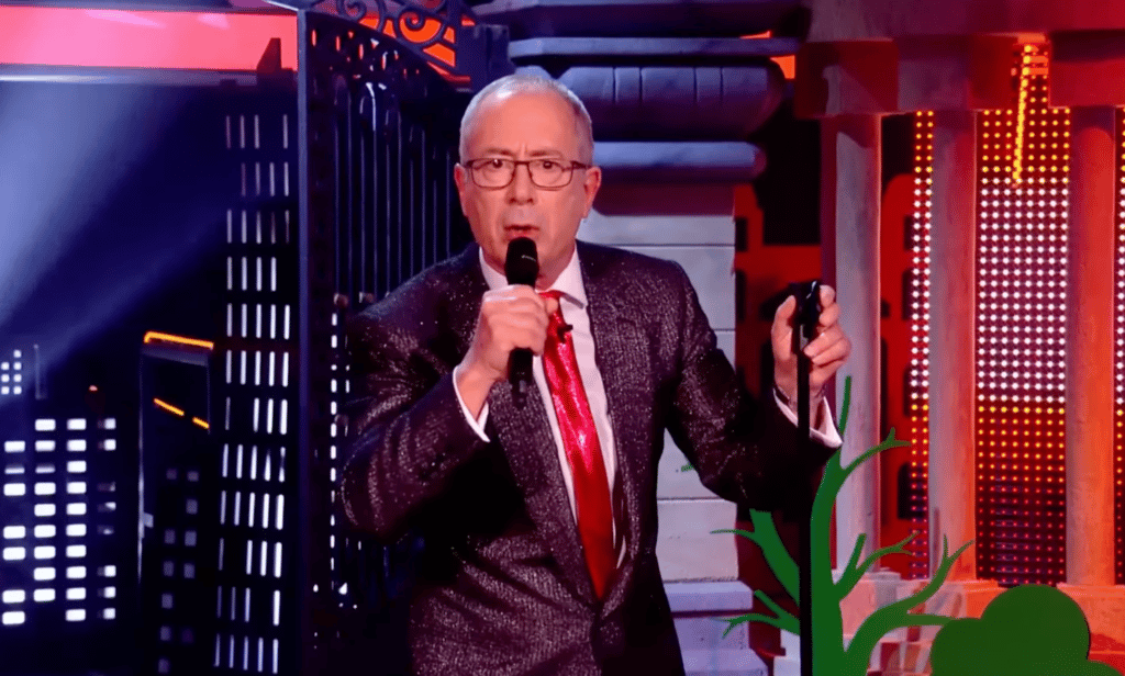 Ben Elton speaks into the microphone during the opening monologue to Channel 4