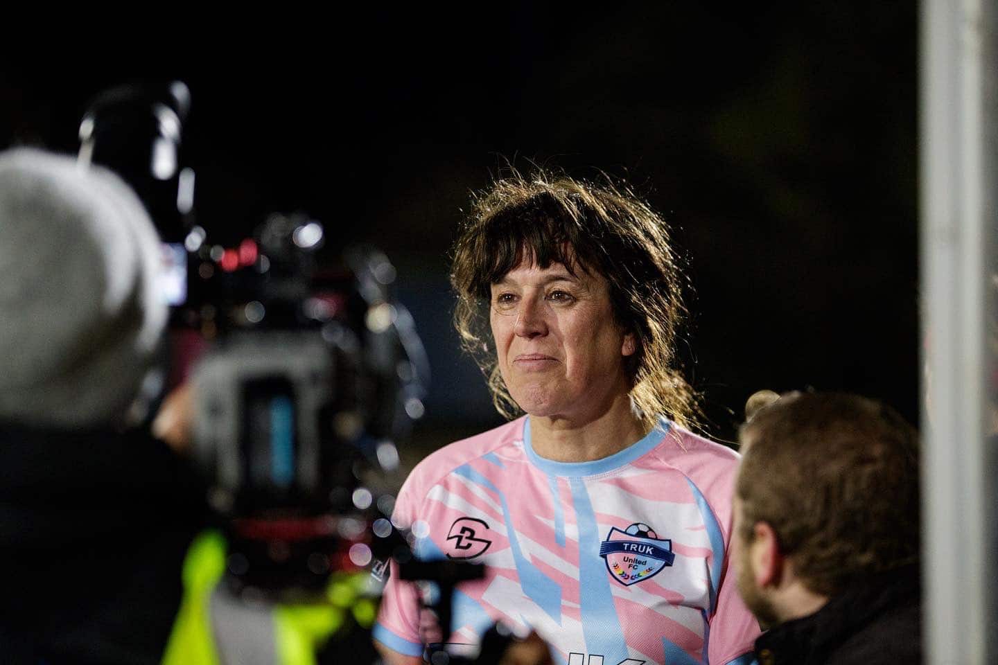 A photo of trans woman Paula Griffin in front of a camera after playing a match with her women