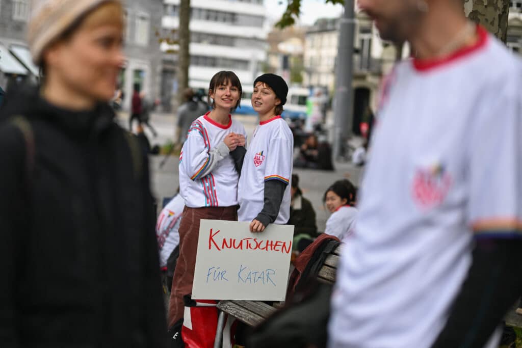 Two women stand with a board