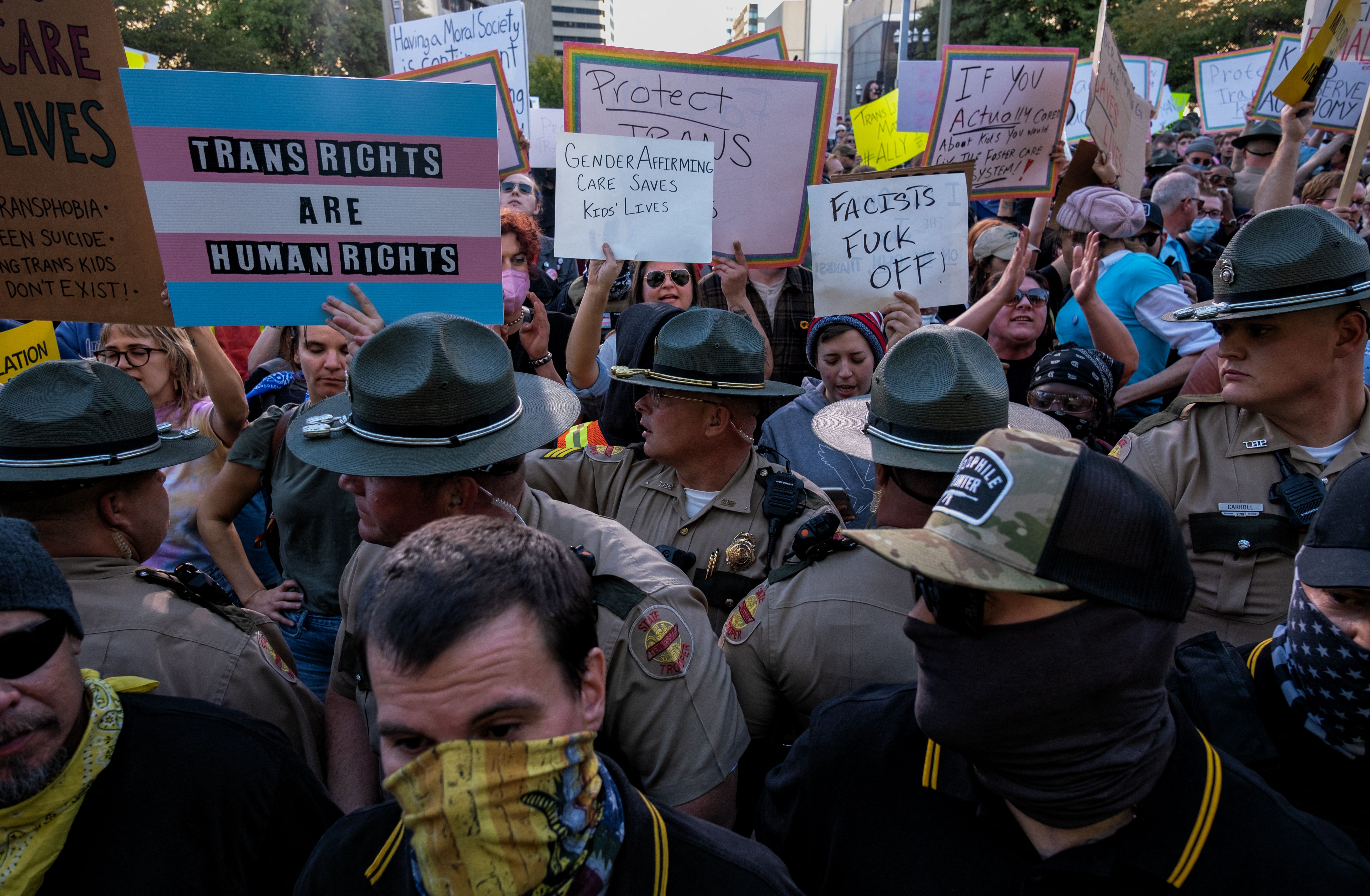 A photo shows Tennessee State Police standing between members of far-right group Proud Boys and counter protestors during a protest against gender-affirming care