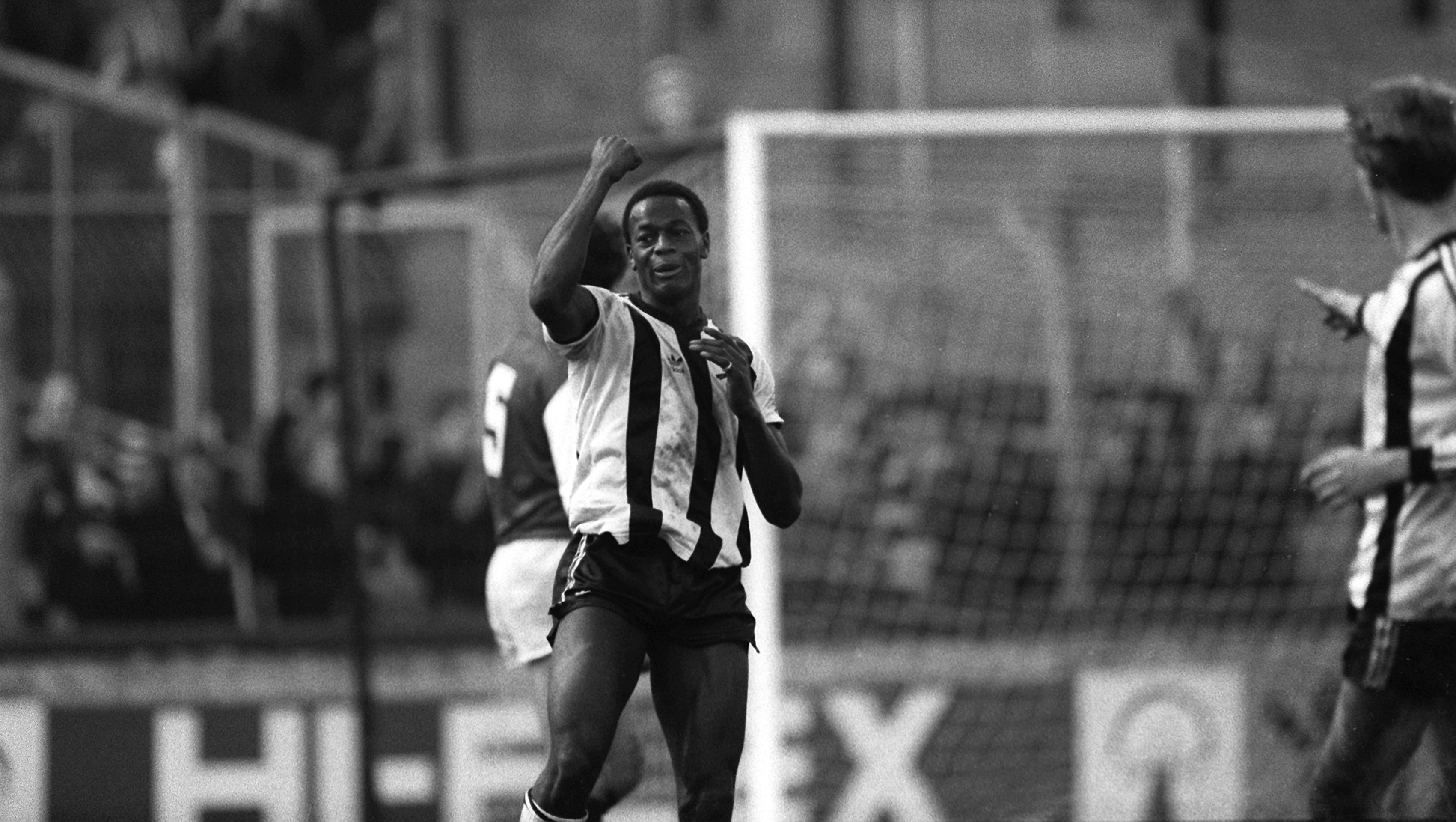A black and white photo showing Norwich City footballer Justin Fashanu in action during a game in 1983