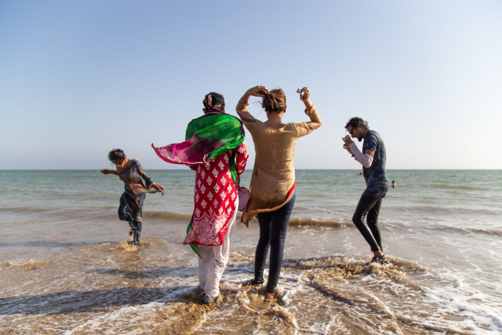 Members of the transgender community play in the water during a picnic ahead of the Women