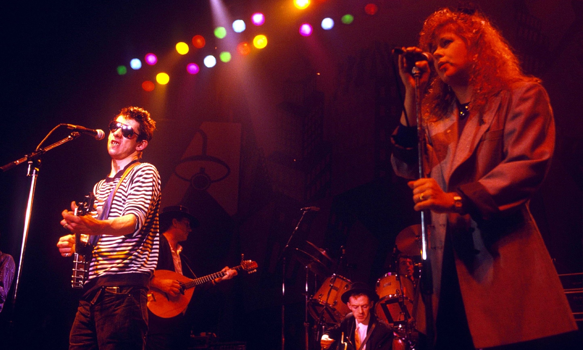 The Pogues perform Fairytale of New York with Kirsty MacColl on stage. (Getty)