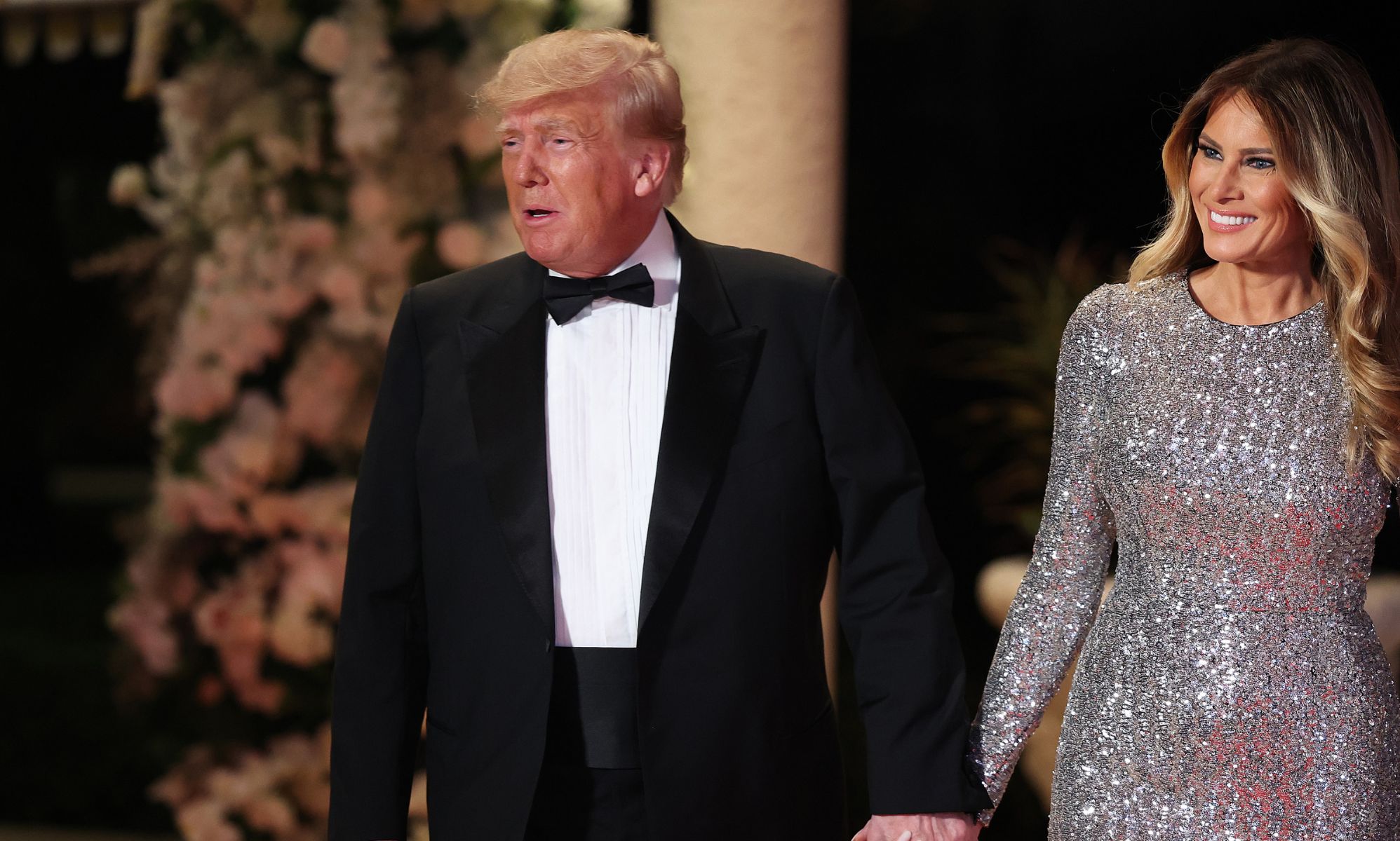 Donald Trump and wife Ivanka walk side by side holding hands while at their New Year