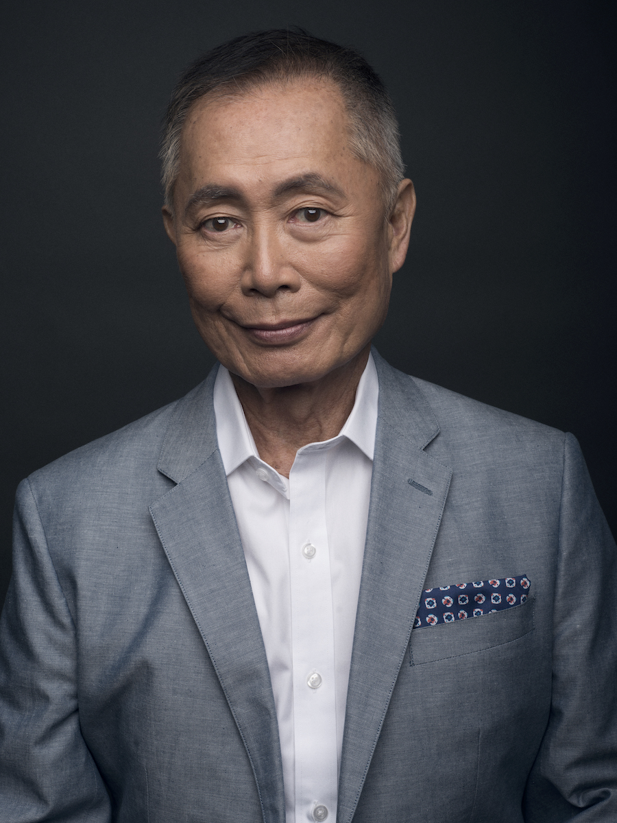 George Takei in a grey suit jacket and white shirt