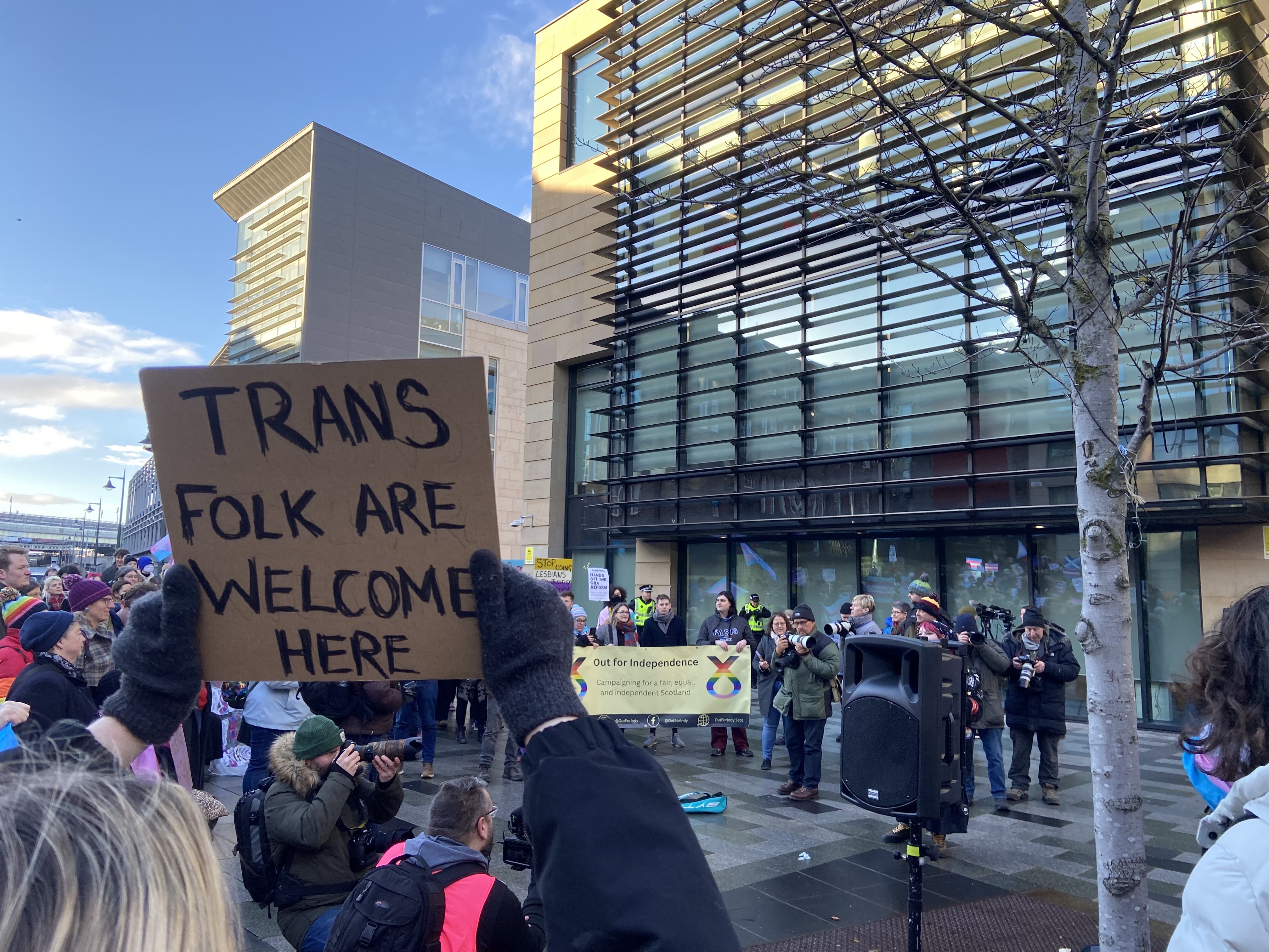 protesters hold signs