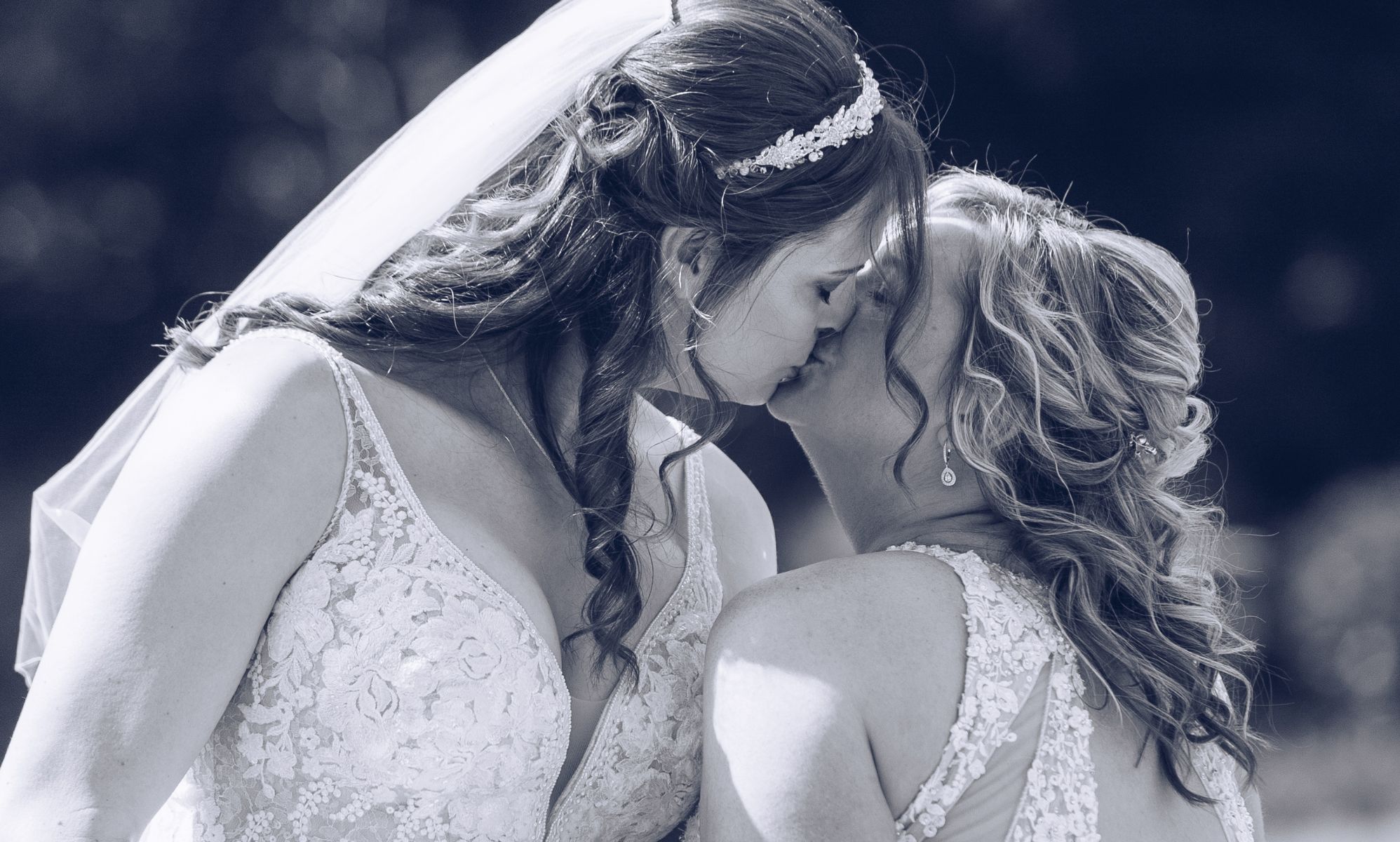 Sophie Rebecca and her partner both wear wedding dresses and kiss as they get married