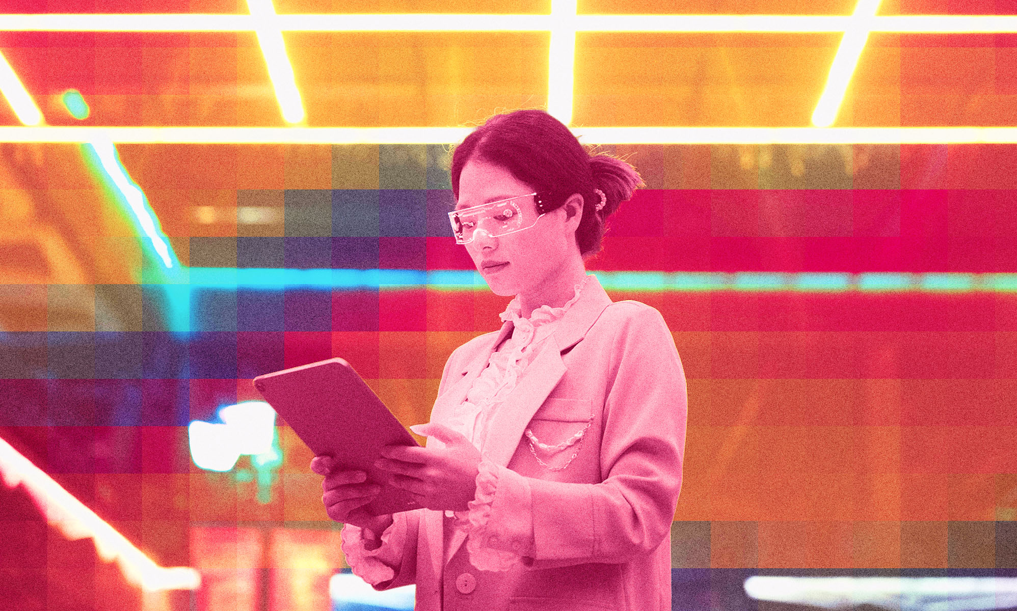 A woman is looking down at a tablet.