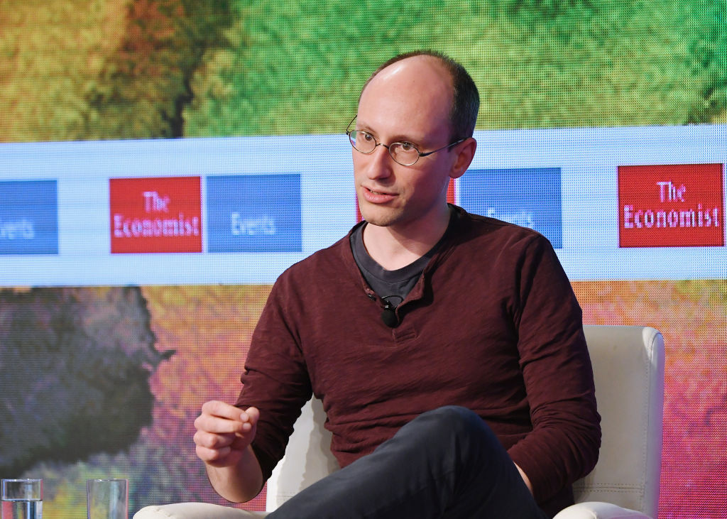 Peter Arvai is seated while speaking on a panel.
