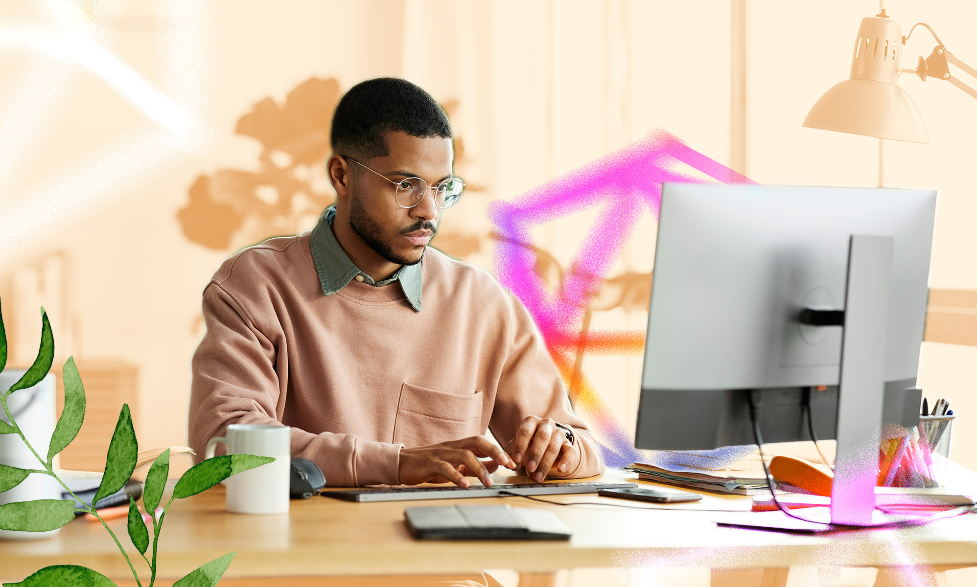 A man is sitting behind his computer.