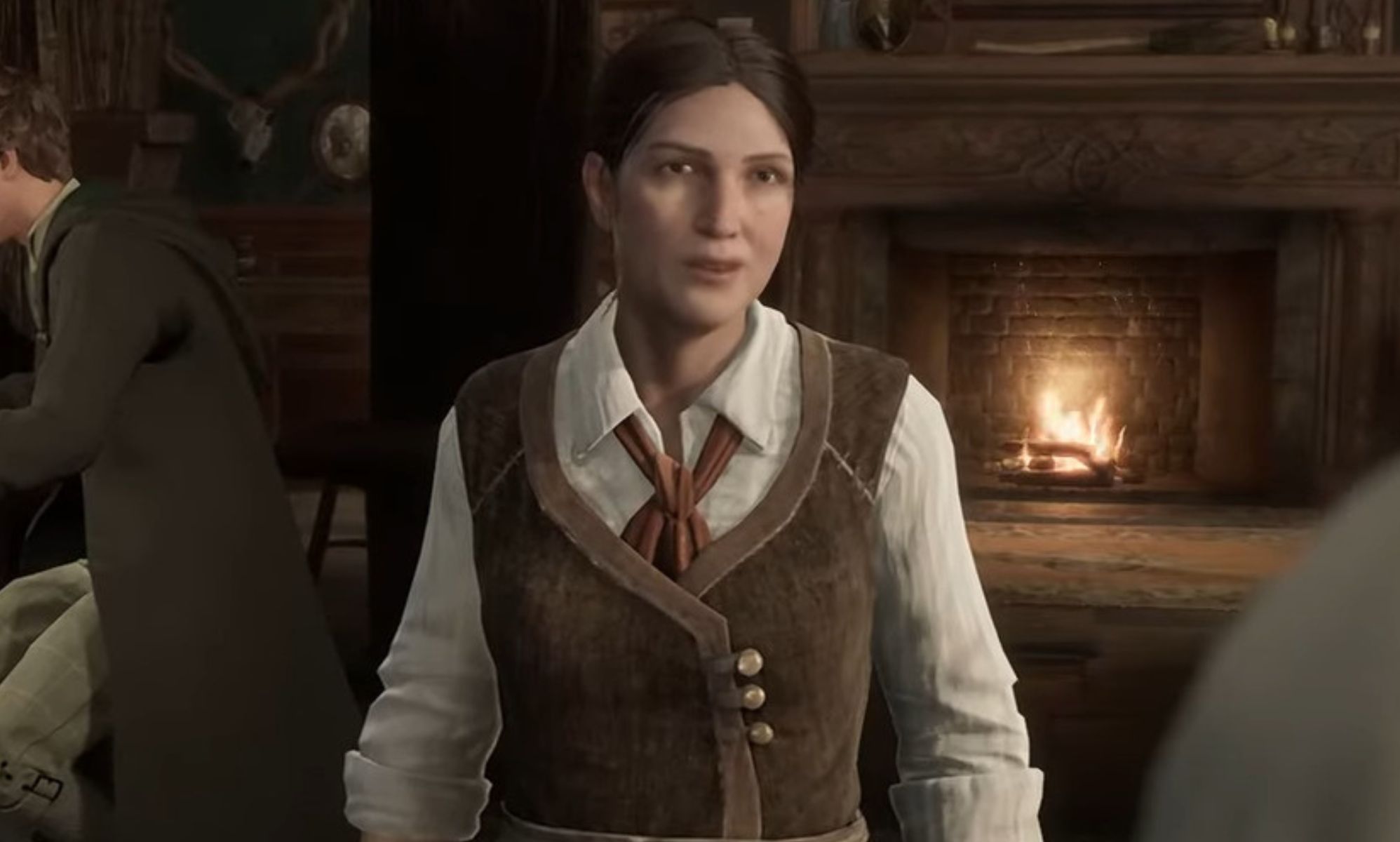 A screenshot from Hogwarts Legacy video game showing trans character Sirona Ryan wearing a white shirt and brown waistcoat