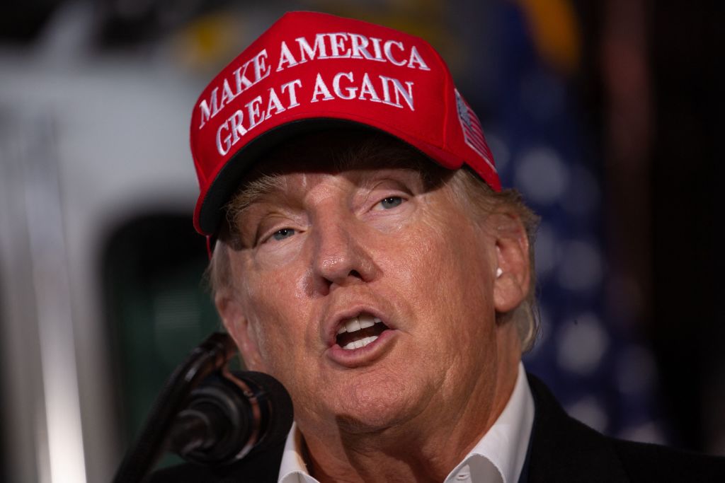 Donald Trump wearing a &quot;Make America Great Again&quot; cap while speaking at a rally.