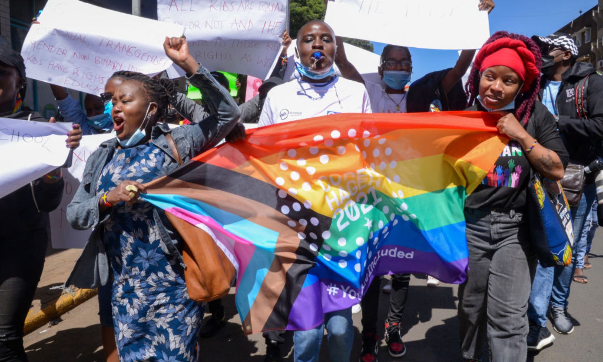 Demonstrators are seen marching with an LGBTQ flag during a protest in Nairobi.