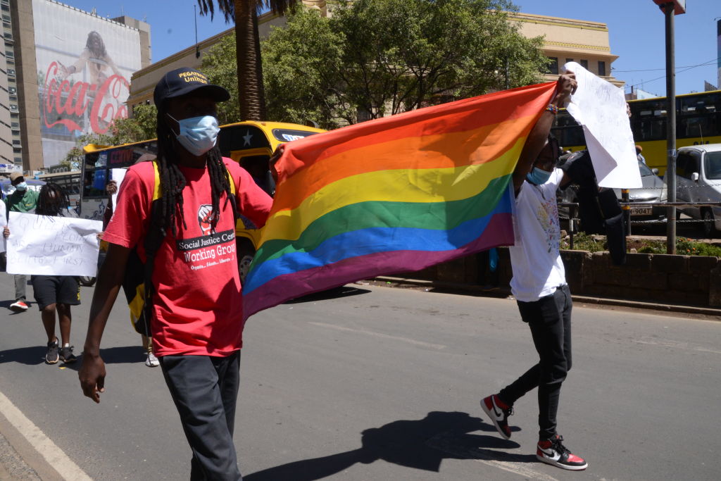 Demonstrators are seen marching with an LGBTQ flag during a protest in Nairobi.
